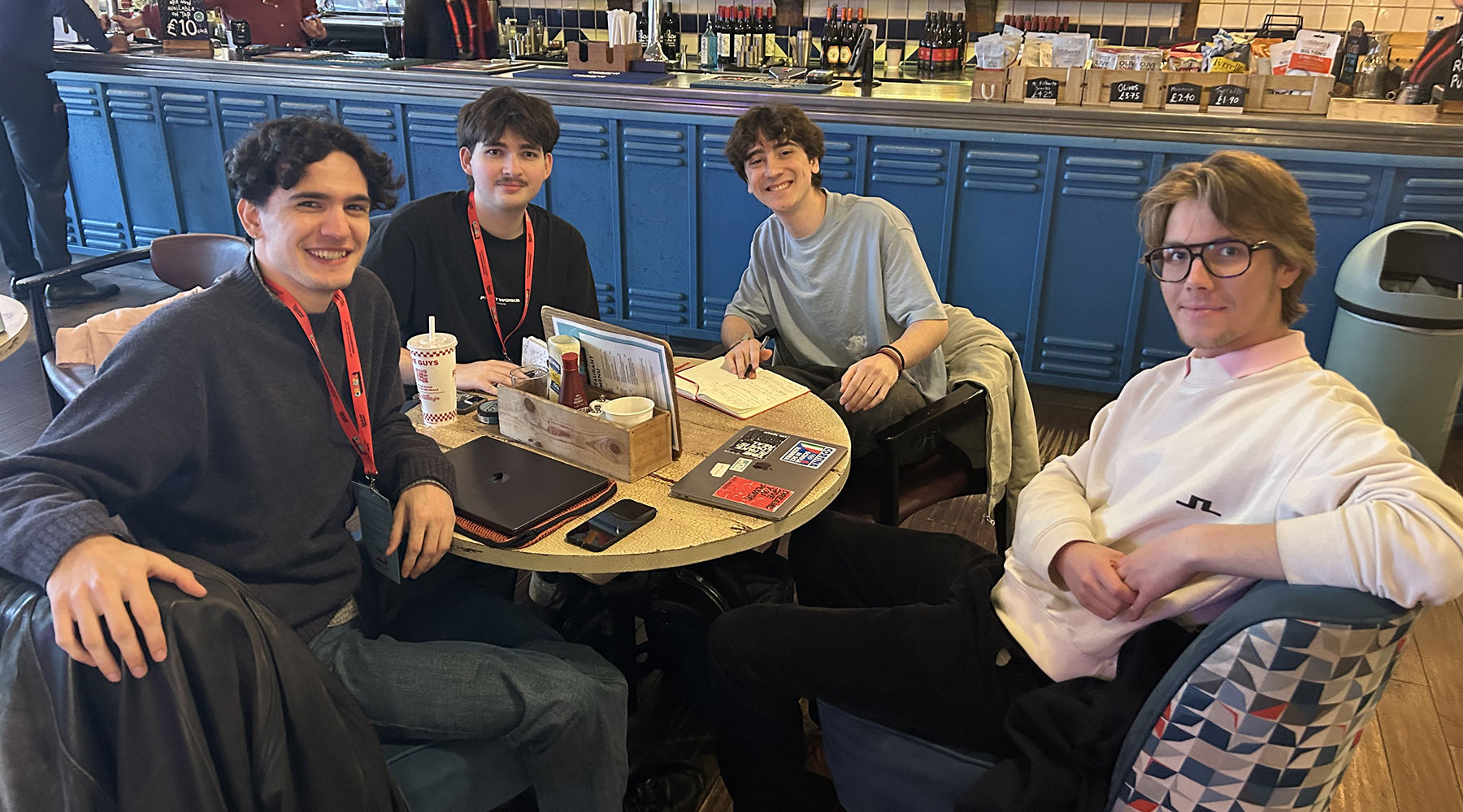Four students smiling to camera